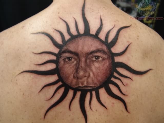 Human Face In Sun Tattoo On Upper Back