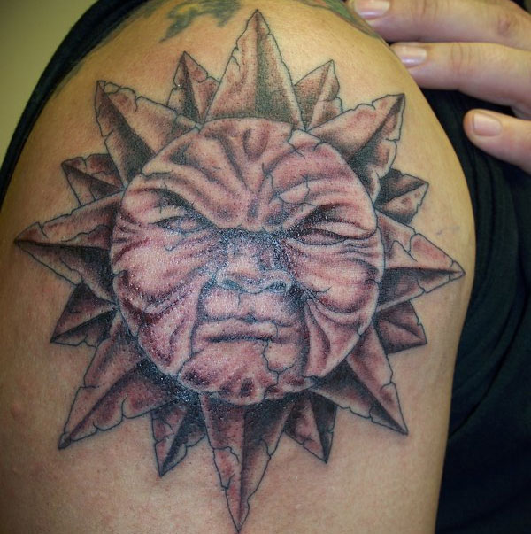 Old Angry Sun Tattoo On Man Shoulder