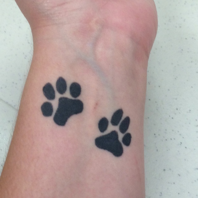 Silhouette Two Paw Prints Tattoo On Wrist