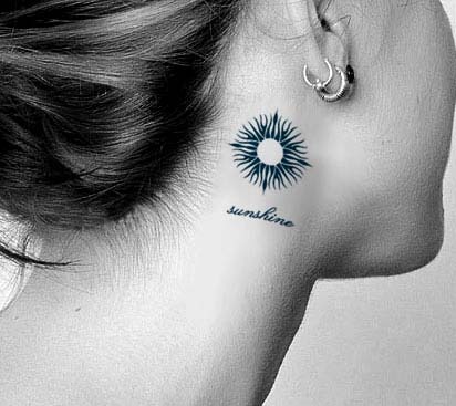Unique Black Sun Tattoo On Girl Behind The Ear