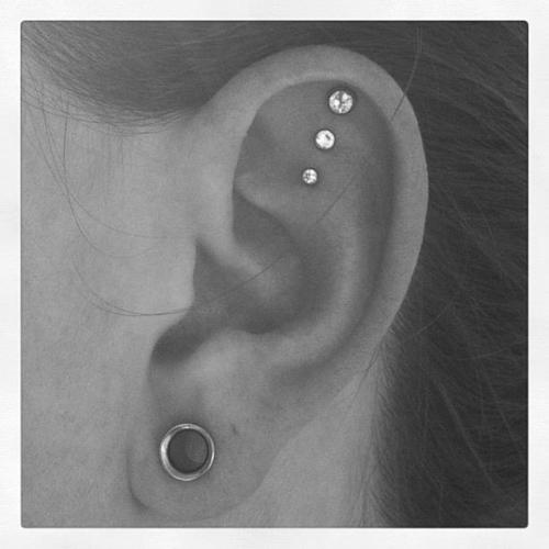 Stretched Lobe And Triple Inner Helix Piercing