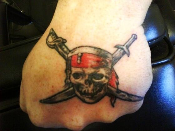 Amazing Pirate Skull With Two Swords Crossing Tattoo On Hand By Gord Kennedy