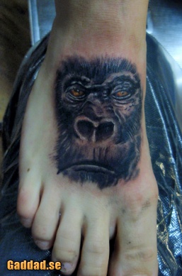 Black And Grey 3D Gorilla Face Tattoo On Foot