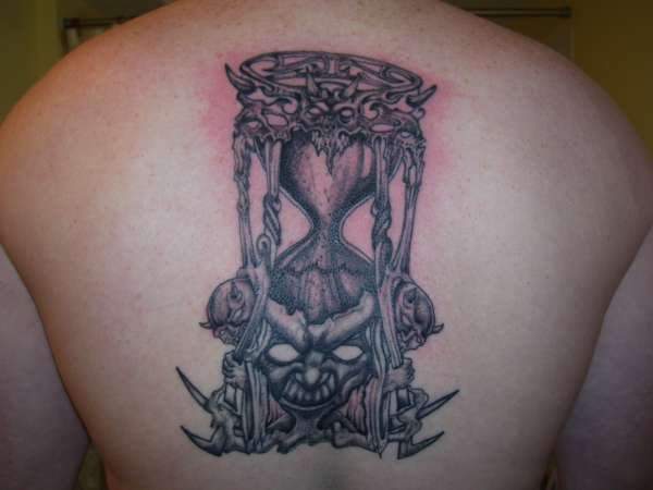 Black And Grey Demon Hourglass Tattoo On Upper Back
