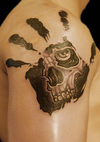 Black And Grey Human Head Skeleton In Hand Print Tattoo On Man Shoulder