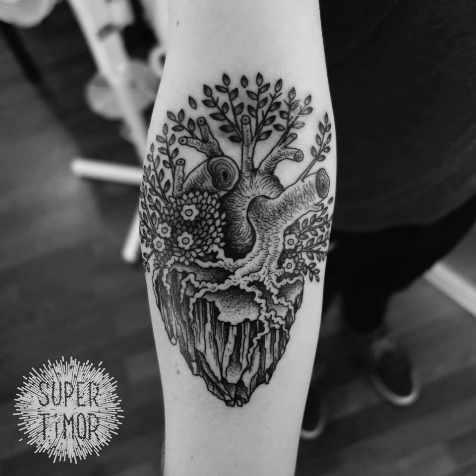 Black And Grey Real Tree Heart Tattoo On Forearm