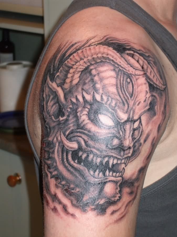 Black And Grey Scary Demon Face Tattoo On Man Shoulder