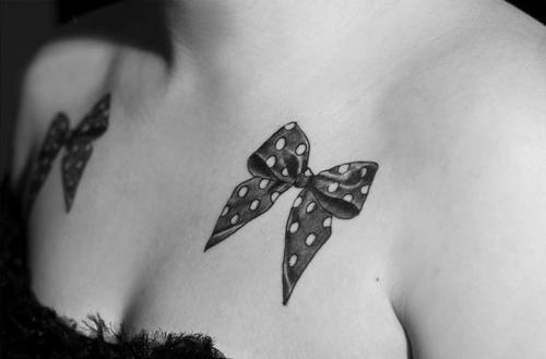 Black And Grey Two Dotted Bow Tattoo On Girl Chest