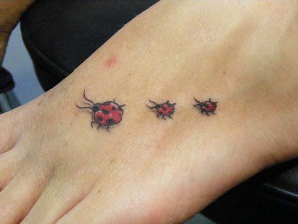 Black And Red Three Little Ladybird Tattoo On Foot