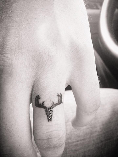 Black Deer Head Ring Tattoo On Finger