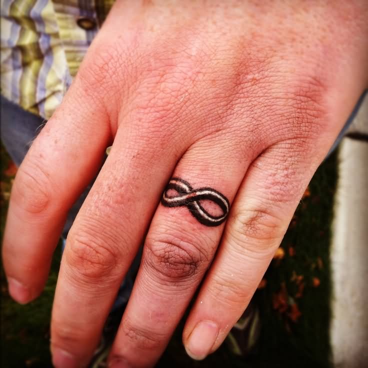 Black Infinity Ring Tattoo On Finger