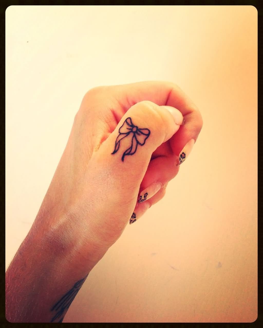 Black Little Bow Tattoo On Hand Thumb By Simone
