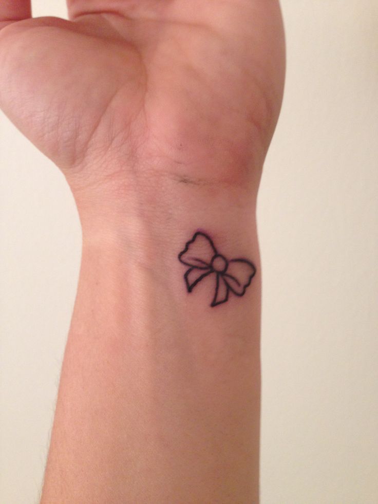 Black Little Bow Tattoo On Wrist