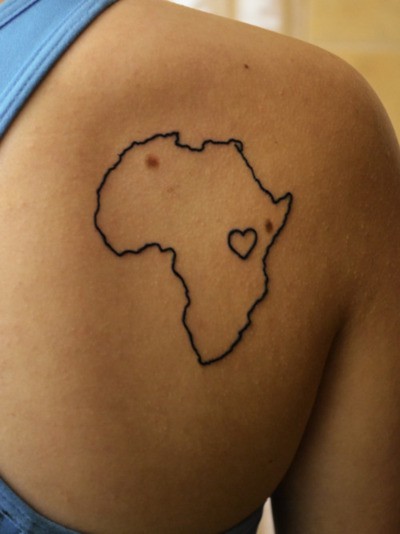 Black Little Heart In African Map Outline Tattoo On Right Back Shoulder