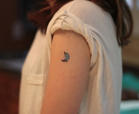 Black Tiny Boat Tattoo On Girl Left Shoulder