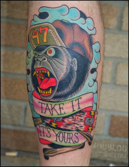 Cap On Roaring Gorilla Head With Banner Tattoo On Leg Calf