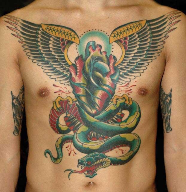 Colorful Real Heart With Wings And Snake Tattoo On Man Chest