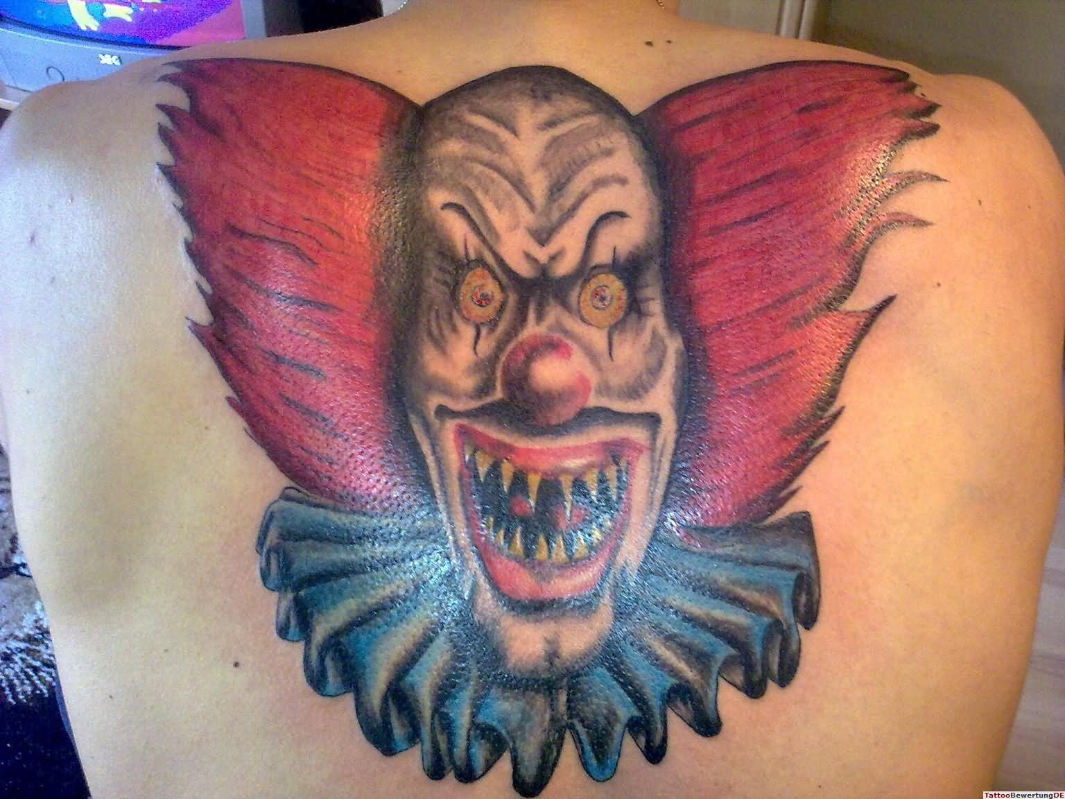 Colorful Scary Clown Face Tattoo On Upper Back