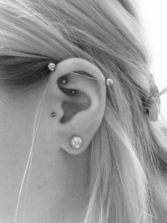 Industrial And Rook Piercing On Girl Left Ear