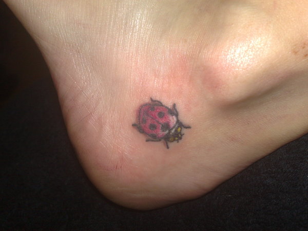 Red And Black Ladybird Tattoo On Heel By Emma