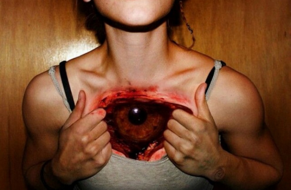 Red And Black Ripped Skin Scary Eye Tattoo On Chest