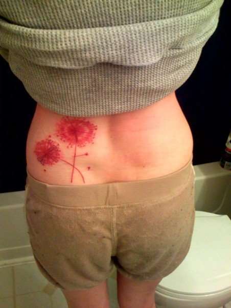 Red Two Dandelion Tattoo On Lower Back
