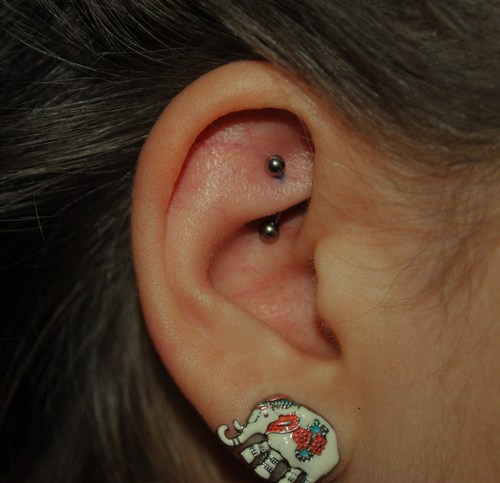 Right Ear Lobe And Curved Barbell Rook Piercing
