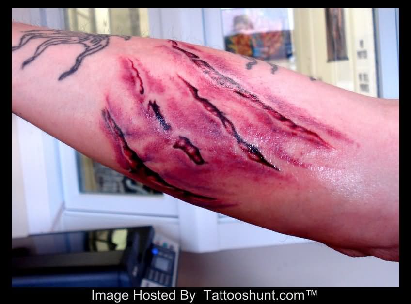Ripped Skin Paw Scratches Tattoo On Forearm.