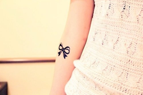 Silhouette Bow Tattoo On Girl Forearm