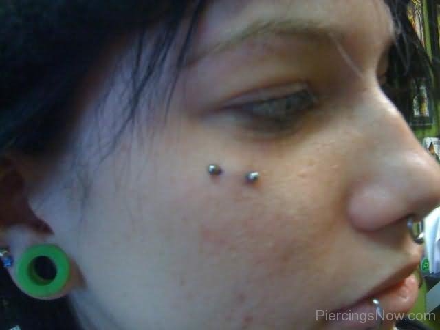 Stretched Ear Lobe And Butterfly Kiss Piercing With Silver Barbell