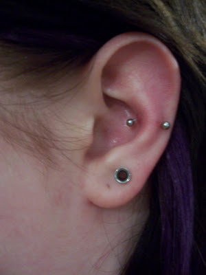 Stretched Ear Lobe And Silver Barbell Snug Piercing