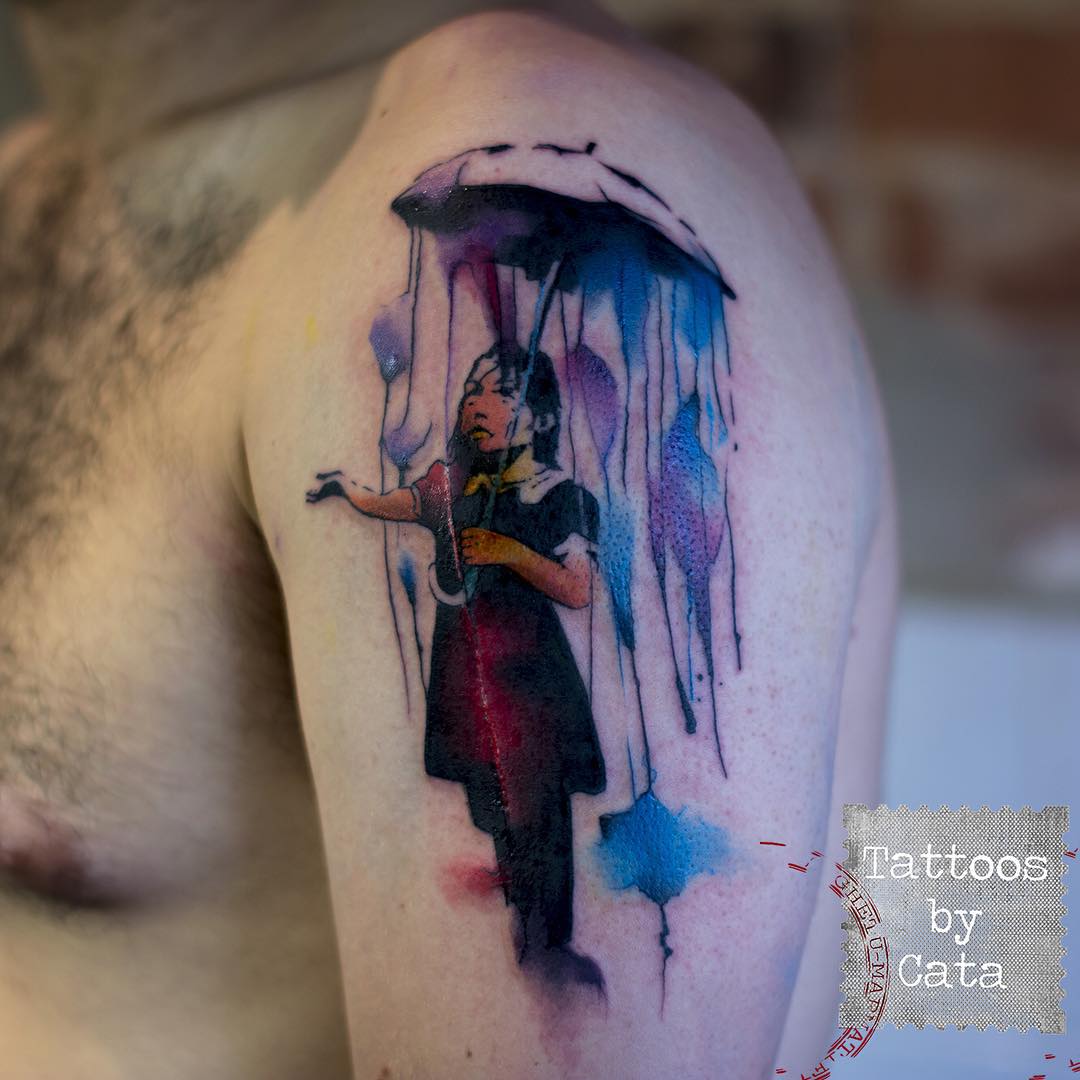 Watercolor Banksy With Umbrella Tattoo On Man Shoulder By Cata