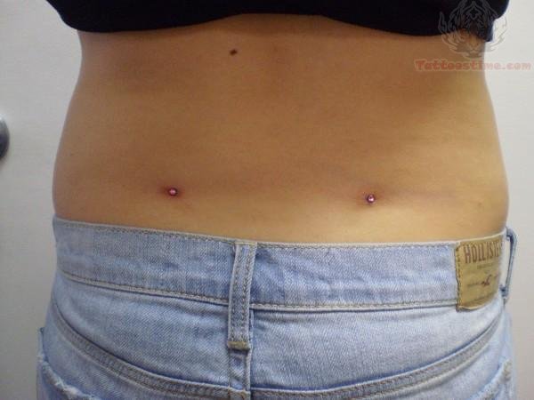 Back Dimple Piercing With Pink Dermal Anchors