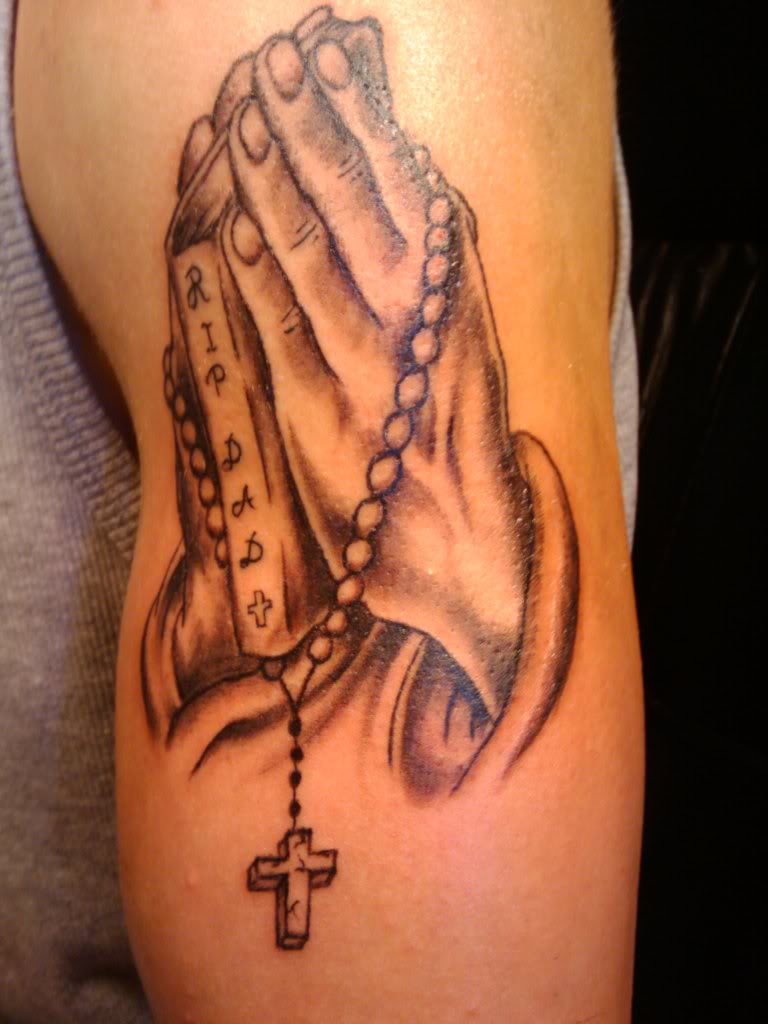 Black And Grey Rosary Cross In Praying Hand Tattoo On Bicep