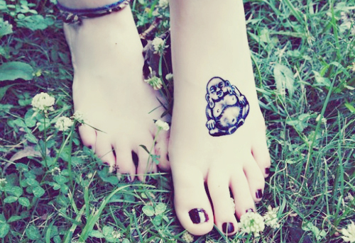 Black Buddhist Tattoo On Girl Left Foot