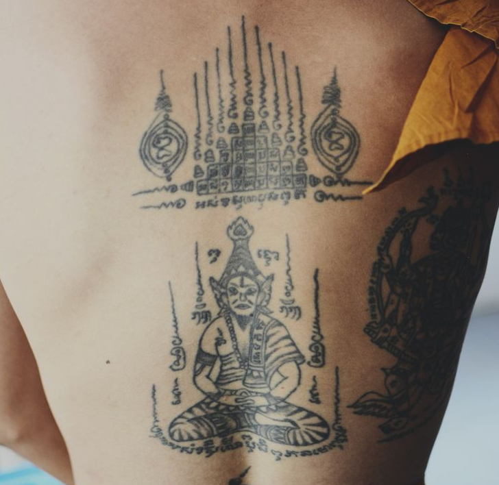 Black Buddhist Tattoo On Man Back