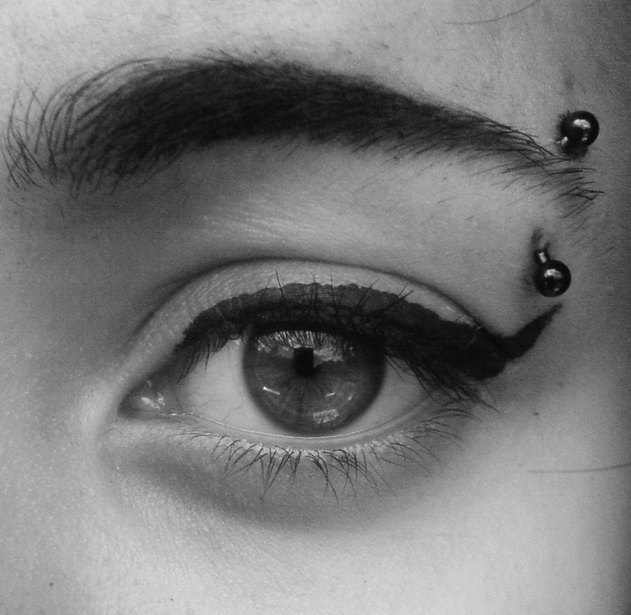 Black Ink Curved Barbell Eyebrow Piercing
