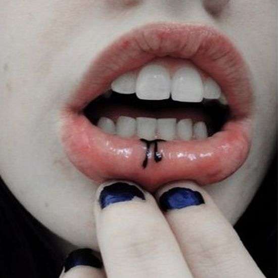 Black Pi Tattoo On Girl Inner Lip