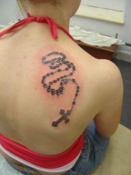 Black Rosary Cross Tattoo On Girl Right Back Shoulder
