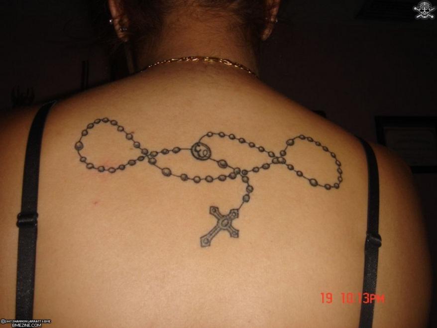 Black Rosary Cross Tattoo On Girl Upper Back