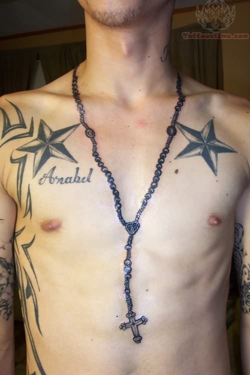 Black Rosary Cross With Two Nautical Star Tattoo On Man Chest