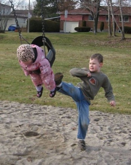 Boy Kicking Kid On Swinging Funny Picture