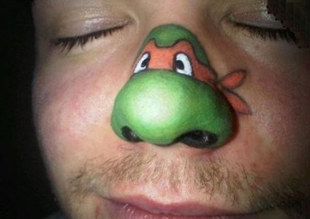 Colorful Funny Turtle Face Tattoo On Man Nose