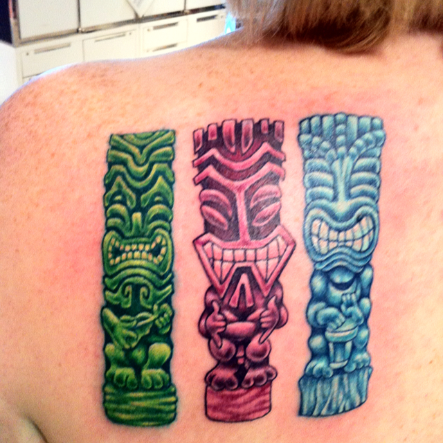 Colorful Three Tiki Tattoo On Upper Back