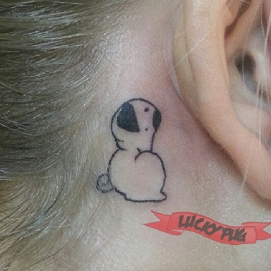 Cute Black Pug Dog Tattoo On Girl Behind The Ear