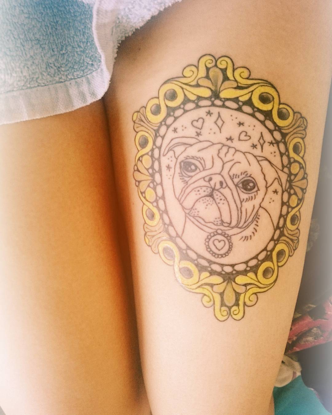 Cute Pug In Frame Tattoo On Girl Left Thigh