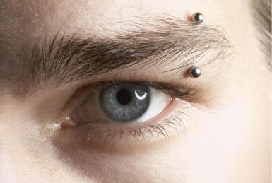 Left Eyebrow Piercing With Silver Barbell
