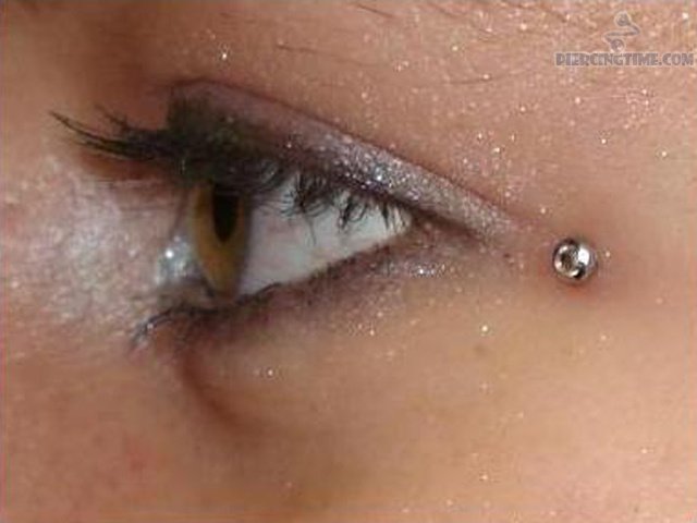Silver Stud Eye Piercing Closeup Image