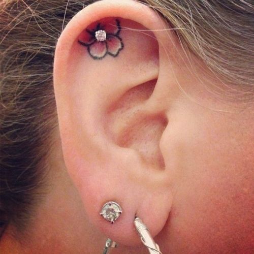 Small Flower Tattoo And Dermal Anchor Inside Ear Piercing