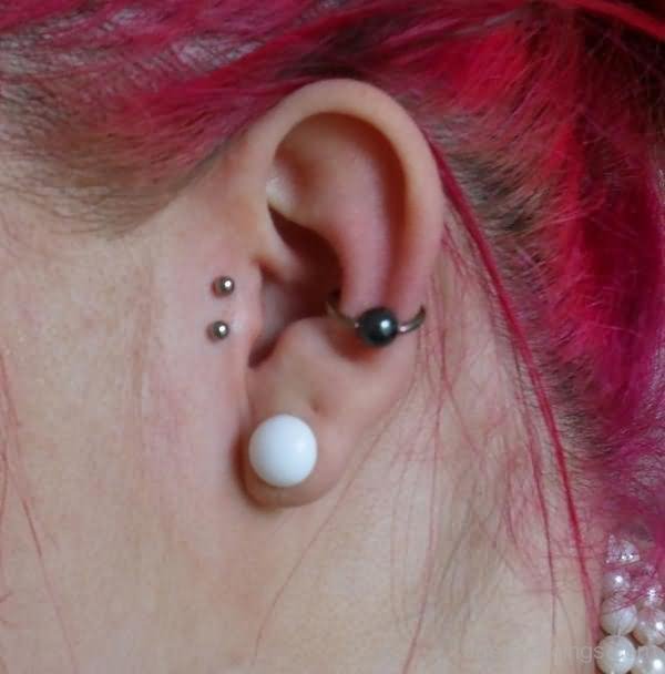 Surface Tragus And Lobe Piercing With Orbital Piercing On Left Ear